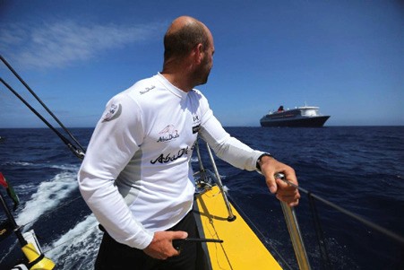 Volvo Ocean Race skipper Ian Walker looks back as RMS Queen Mary 2 overtakes Abu Dhabi Ocean Racing’s Volvo Ocean 65 Azzam in the Atlantic. © Matt Knighton/Abu Dhabi Ocean Racing