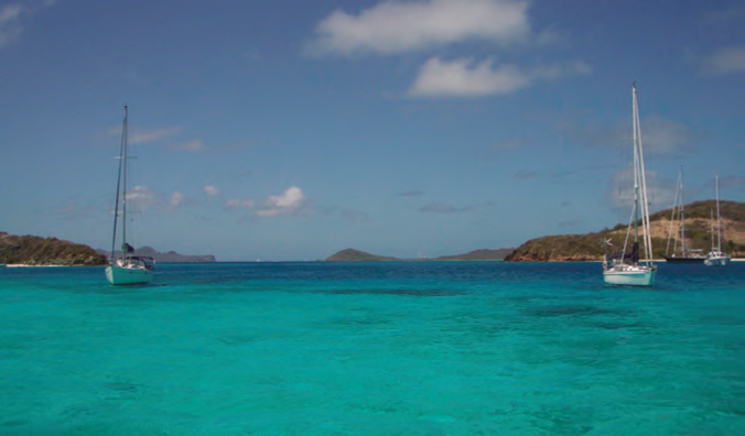 At anchor off Baradel in the Tobago Cays, with Baradel to the right, Petit Rameau center, and Petit Bateau to the left. The water colors are incredible! © Nancy Kaull