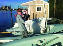 Sacred Heart University team captain Brian Reilly and Jess Ainsley rig an FJ on the Island Dock at Captain’s Cove Seaport. © Dave White