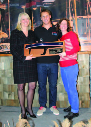 Janet Coit (left), Rhode Island Department of Environmental Management Director, presents the John H. Chafee 2014 Boater of the Year award to Rome Kirby. Also pictured is Wendy Mackie (right), CEO of RIMTA. Photo courtesy of the Providence Boat Show