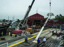 The foremast of the Charles W. Morgan is lifted up to be lowered into position on the ship at Mystic Seaport, Thursday, October 17, 2013. © Andy Price/Mystic Seaport.