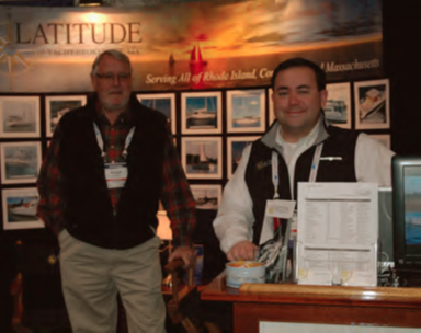 Ryan Miller (right) noted an increase in the number of serious buyers at the Providence Boat Show. On the left is Latitude Yacht Broker Tim Norton.