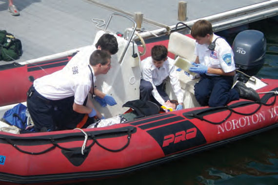 Suspecting a spinal injury, the Emergency Medical Technicians from Darien EMS Post 53 checked the stricken sailor’s vital signs and stabilized him before transporting him to an ambulance