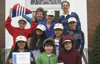 Kevin Wing (in red) holds the Greenwich Sail and Power Squadron