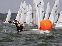 Using your sails and your weight to steer the boat around a windward mark will help keep you out in front. © Spectrum Photo/Fran Grenon